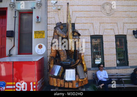 a wooden carved statue commemorating firefighters form brooklyn squad 1 killed on sep 11 Stock Photo