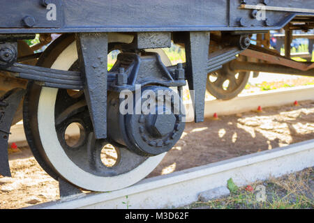 Moving wheels of retro red tram. close up Stock Photo