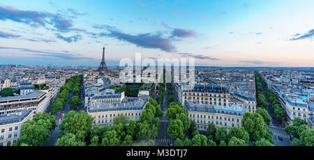 Sunset skyline of Paris with Eiffel tower and streets with trees Stock Photo
