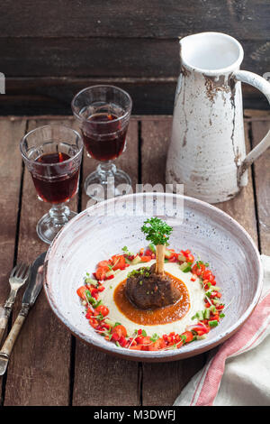 Lamb shank with eggplant puree and fresh vegs, traditional turkish dish Stock Photo