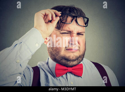 Man wearing eyeglasses and having expression of aversion looking at camera. Stock Photo