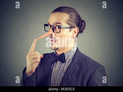 Liar businessman with long nose Stock Photo