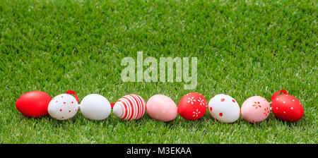 Easter concept. Colorful eggs on green grass, banner, space for text Stock Photo