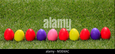 Easter concept. Colorful eggs on green grass, banner, space for text Stock Photo