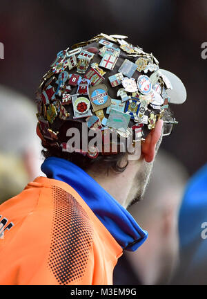 A Burnley fan wears a hat covered in pin badges during the Premier League match at the Liberty Stadium, Swansea. PRESS ASSOCIATION Photo. Picture date: Saturday February 10, 2018. See PA story SOCCER Swansea. Photo credit should read: Simon Galloway/PA Wire. RESTRICTIONS: EDITORIAL USE ONLY No use with unauthorised audio, video, data, fixture lists, club/league logos or 'live' services. Online in-match use limited to 75 images, no video emulation. No use in betting, games or single club/league/player publications Stock Photo