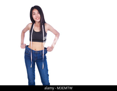 weight loss woman wearing her old jeans and measure tape isolated on a white background Stock Photo