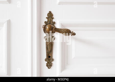 old door handle closeup on wooden door in beautiful apartment - interior Stock Photo