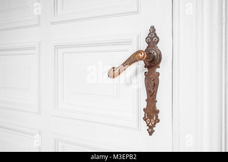 beautiful old door handle on wooden door inside old building apartment - interior