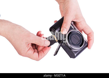 Insert memory card into the camera. Woman's hands on a white background. Stock Photo