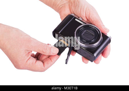 Insert memory card into the camera. Woman's hands on a white background. Stock Photo