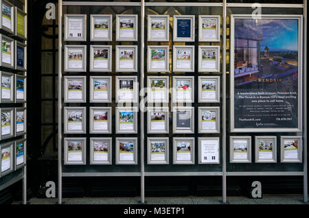 Properties photos with price displaying the windows of a real estate agency office.Manhattan.New York City.USA Stock Photo