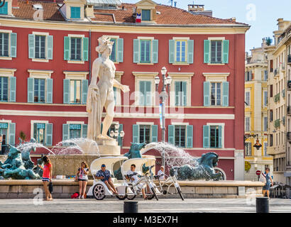 France, Alpes-Maritime department, Côte d'Azur, Nice, Fontaine du Soleil with Apollo statue on Place Masséna, against the backdrop of the characterist Stock Photo