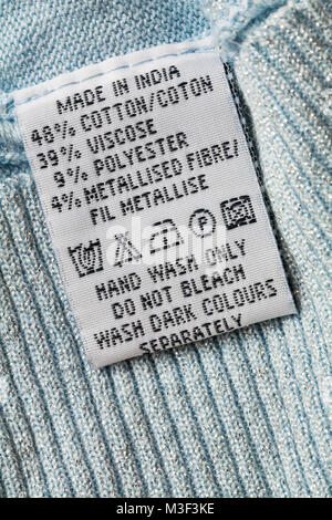 wash care instructions and symbols on label in garment clothing made in India - hand wash only do not bleach wash dark colors separately Stock Photo