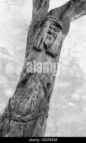 Wood carved statue of crucified Jesus Christ. Strange artistic statue. Stock Photo