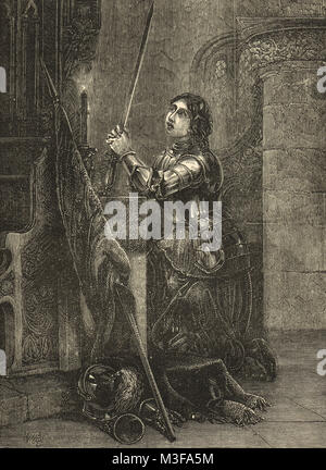 Joan of Arc in armour knelt in prayer Stock Photo