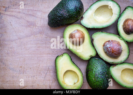 Persea americana. Avocado pattern on a wood background Stock Photo