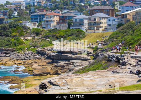 People walking the Bondi to Coogee coastal walk approach Mackenzies bay,Sydney,Australia Stock Photo