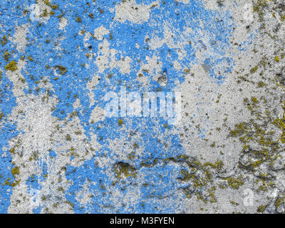 Texture of the cement wall. Texture with blue and white paint, scratches, part of the texture with lichen. Stock Photo