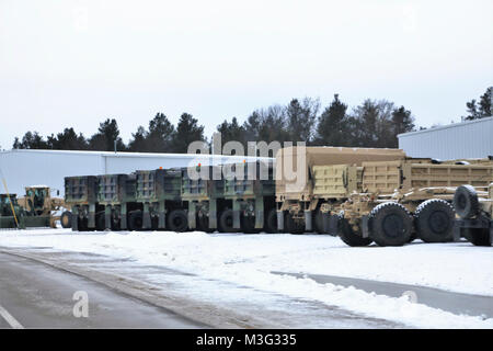 Army military vehicles are parked at a staging area Jan. 24, 2018, on the cantonment area at Fort McCoy, Wis. The vehicles were staged prior to being weighed and shipped by rail from the installation. (U.S. Army Stock Photo