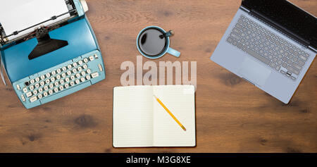 Electric typewriter and laptop on wood background Stock Photo