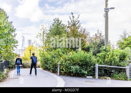 Brooklyn, USA - October 28, 2017: Dumbo outside exterior outdoors in NYC New York City, people walking in green, urban Main Street Park Stock Photo