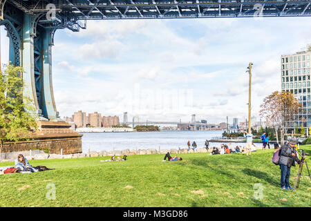 Brooklyn, USA - October 28, 2017: Dumbo outside exterior outdoors in NYC New York City, people in green, urban Main Street Park, cityscape skyline and Stock Photo