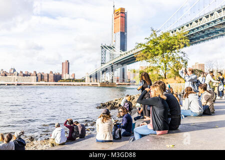Brooklyn, USA - October 28, 2017: Dumbo outside exterior outdoors in NYC New York City, people in urban Main Street Park, cityscape skyline and bridge Stock Photo