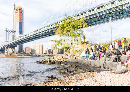 Brooklyn, USA - October 28, 2017: Dumbo outside exterior outdoors in NYC New York City, people in urban Main Street Park, cityscape skyline and bridge Stock Photo