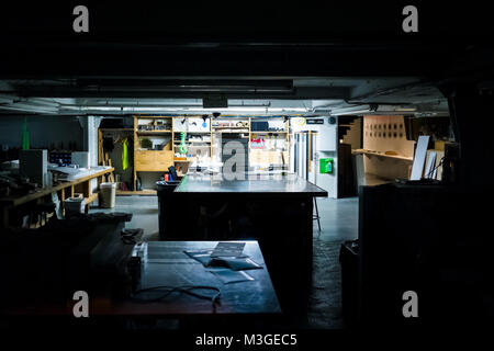 Urban dark evening night illuminated office art studio room with light, table, equipment workshop classroom, architecture Stock Photo