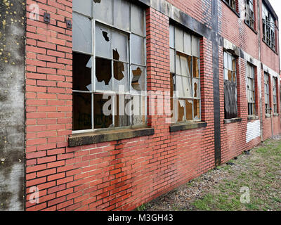 Exterior of abandoned brick building with broken windows in Montgomery Alabama, USA. Stock Photo