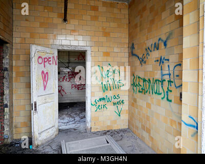 Interior of abandoned building with graffiti painted on the tile walls in an industrial section of Montgomery Alabama, USA. Stock Photo