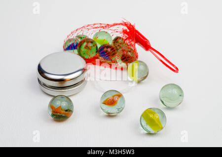 A Studio Photograph of Glass Marbles and a Silver Coloured Yoyo Stock Photo