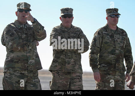 Major General Steven W. Ainsworth, commanding general, 377th Theater Sustainment Command; Maj. Gen. Mark Palzer, commanding general, 79th Sustainment Support Command; and Brig. Gen. Gregory Mosser, commanding general, 364th Expeditionary Sustainment Command, observe transloading operations at Khabari Crossing on the Kuwait-Iraq border, Feb. 4, 2018, during Joint Monthly Access for Reserve Component (JMARC), a quarterly opportunity for senior leaders from the U.S. Army National Guard and Reserve to visit with deployed Soldiers. The JMARC provided the opportunity to reserve leaders to understand Stock Photo