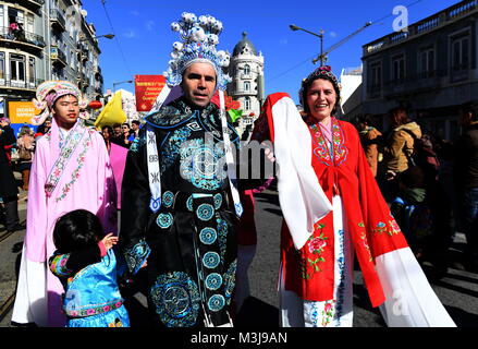 Lisbon. 10th Feb, 2018. Portuguese in Chinese costumes walk in a street during 'Happy Chinese New Year' celebration in Lisbon, capital of Portugal on Feb. 10, 2018. Credit: Zhang Liyun/Xinhua/Alamy Live News Stock Photo