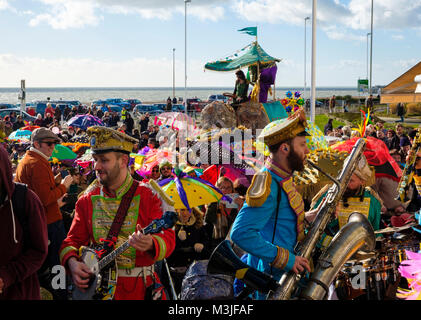 Hastings, East Sussex, UK. 11 Feb 2018. Brilliant sunny day for the parade of the decorated umbrellas at the Fat Tuesday / Mardi Gras carnival. Stock Photo