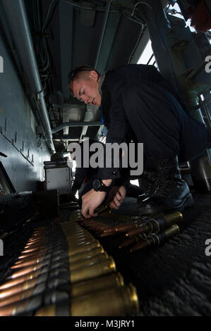 GULF OF THAILAND (Feb. 9, 2018) Gunner's Mate Seaman Cole Parrish, from Prescott Valley, Ariz., connects rounds of .50-caliber machine gun ammunition during small craft action team (SCAT) training aboard the amphibious assault ship USS Bonhomme Richard (LHD 6). Bonhomme Richard is operating in the Indo-Asia-Pacific region as part of a regularly scheduled patrol and provides a rapid-response capability in the event of a regional contingency or natural disaster. (U.S. Navy Stock Photo