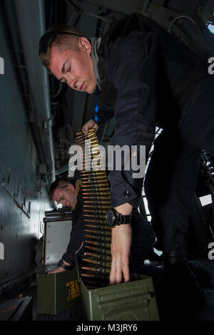 GULF OF THAILAND (Feb. 9, 2018) Gunner's Mate Seaman Cole Parrish, front, from Prescott Valley, Ariz., and Gunner's Mate Seaman Michael Norris, from Oakdale, Calif., store rounds of .50-caliber machine gun ammunition during small craft action team (SCAT) training aboard the amphibious assault ship USS Bonhomme Richard (LHD 6). Bonhomme Richard is operating in the Indo-Asia-Pacific region as part of a regularly scheduled patrol and provides a rapid-response capability in the event of a regional contingency or natural disaster. (U.S. Navy Stock Photo