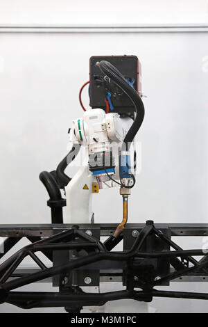 Robotic Arm Welding Metal Components in Factory Stock Photo