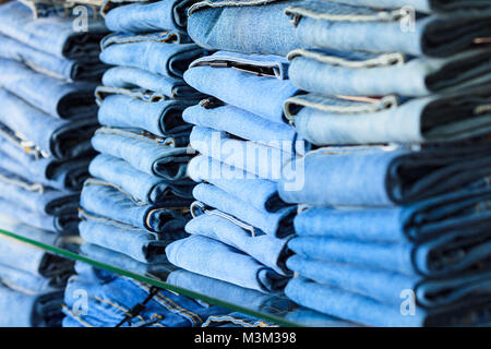 Closeup shot of stack of folded jeans in the fashion store Stock Photo