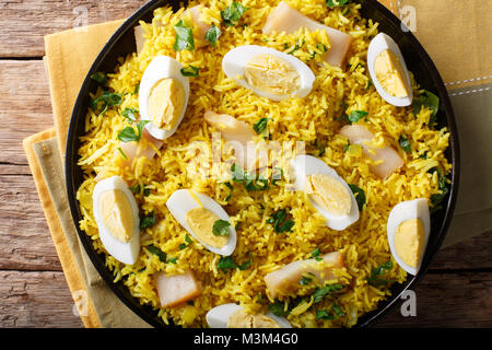 Kedgeree with smoked fish, eggs and spices close-up on a plate. horizontal top view from above Stock Photo