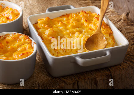 Homemade casserole mac and cheese in a baking dish close-up on a table. horizontal Stock Photo