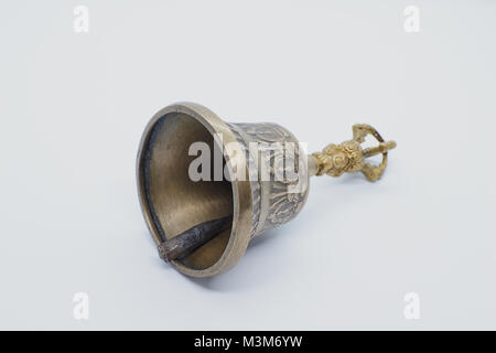 An antique traditional hand bell isolated on a white background Stock Photo