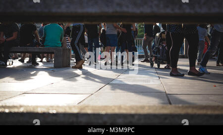London (UK) - August 2017. Panoramic view of people walking along the Queen's walk on the South Bank of the river Thames. Landscape format. Stock Photo