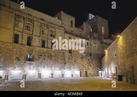 Otranto (Italy), August 2017. Night view of the square in front of Porta Alfonsina (Alfonsina Gate) with the medieval town wall. Landscape format. Stock Photo