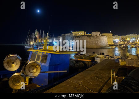 Gallipoli (Apulia - Italy), August 2017. Night view of the Angevine-Aragonese Castle and the old harbour. Landscape format. Stock Photo