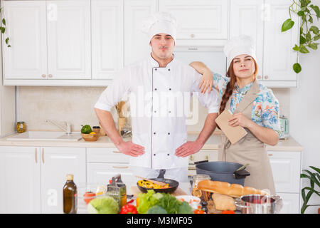 A senior chef giving cooking lesson to young chefs. Stock Photo