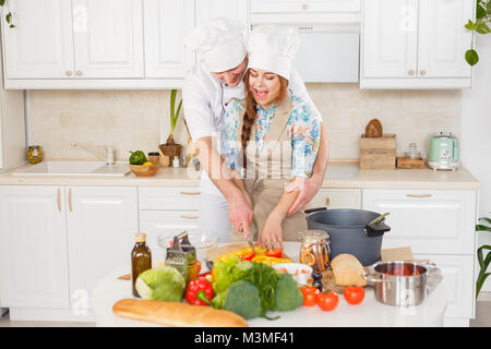 A senior chef giving cooking lesson to young chefs. Stock Photo