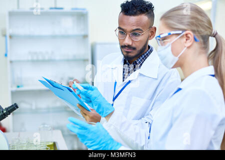Two Young Scientists Working in Lab Stock Photo