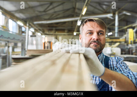Mature Man Working in Joinery Warehouse Stock Photo