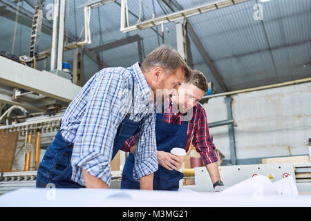 Construction Workers Discussing Plans Stock Photo